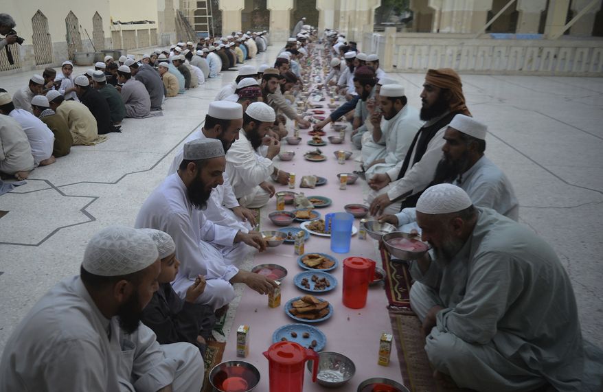 In this photo, Pakistani Muslims wait to break their fast during the fasting month of Ramadan at a mosque in Peshawar, Pakistan, Monday, May 6, 2019. Muslims around the world are observing Ramadan, the holiest month in Islamic calendar. (AP Photo/Muhammad Sajjad) **FILE**