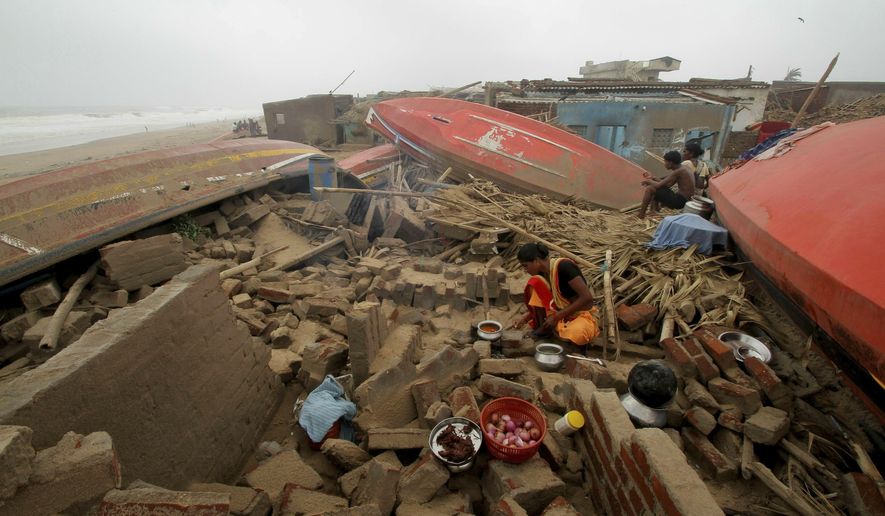 A woman cooks a meal outdoors after her house was damaged by Cyclone Fani in the Penthakata fishing village of Puri, in the eastern Indian state of Orissa, Saturday, May 4, 2019. A mammoth preparation exercise that included the evacuation of more than 1 million people appears to have spared India a devastating death toll from one of the biggest storms in decades, though the full extent of the damage was yet to be known, officials said Saturday. (AP Photo)