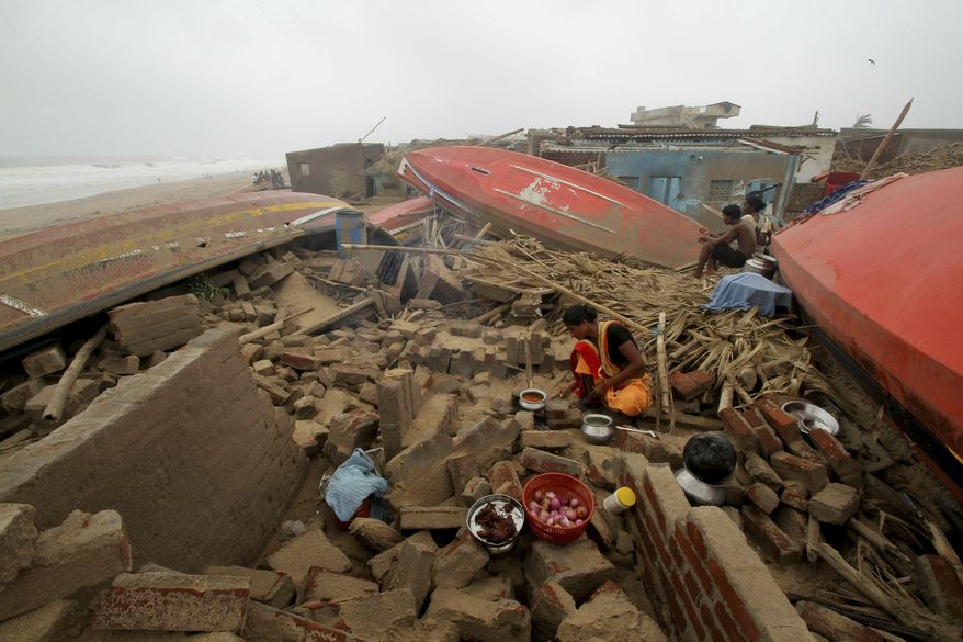 A woman cooks a meal outdoors after her house was damaged by Cyclone Fani in the Penthakata fishing village of Puri, in the eastern Indian state of Orissa, Saturday, May 4, 2019. A mammoth preparation exercise that included the evacuation of more than 1 million people appears to have spared India a devastating death toll from one of the biggest storms in decades, though the full extent of the damage was yet to be known, officials said Saturday. (AP Photo)