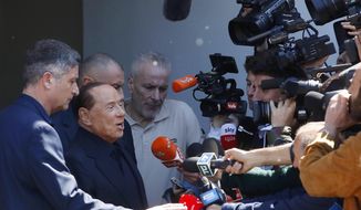 Former Italian Premier Silvio Berlusconi speaks to reporters as he leaves the San Raffaele hospital where he underwent laparoscopic surgery for an intestinal obstruction last week, in Milan, Italy, Monday, May 6, 2019. Berlusconi himself is running for European Parliament elections, the first time he has been allowed to run for public office following a ban imposed after a 2012 tax fraud conviction (AP Photo/Antonio Calanni)