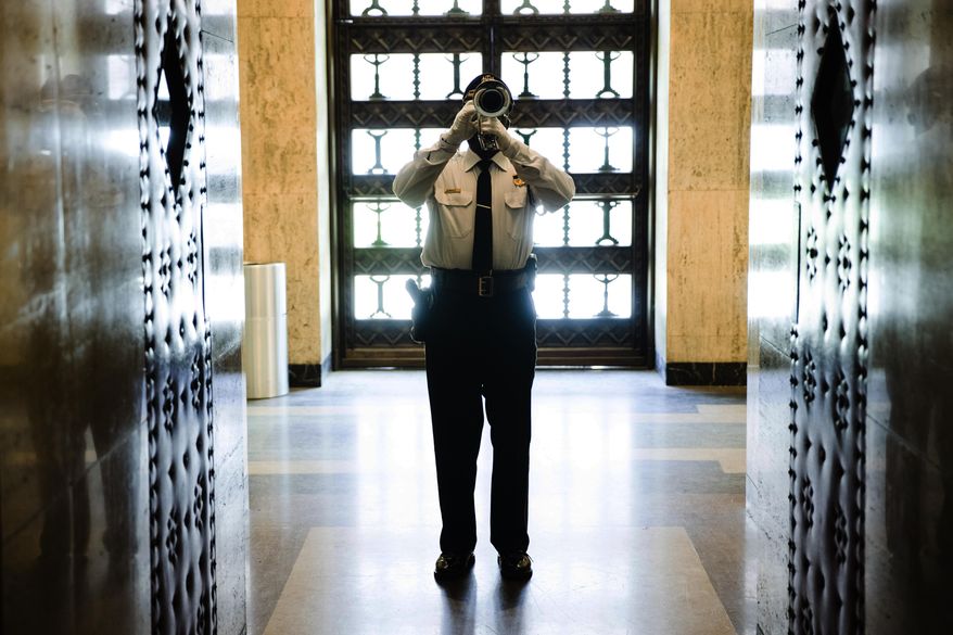 An officer plays "Taps" during the Fraternal Order of Police's annual memorial ceremony honoring members of law enforcement who died or were killed on duty last year at the Forum auditorium in Harrisburg, Pa., Monday, May 6, 2019. (AP Photo/Matt Rourke)