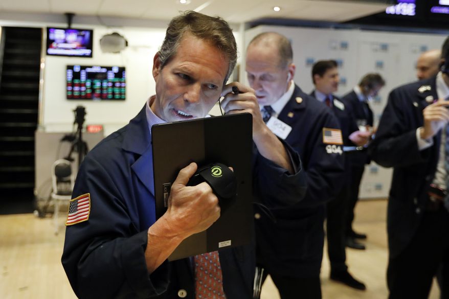 In this May 1, 2019, file photo, trader Robert Charmak, left, works on the floor of the New York Stock Exchange. On Monday, May 6, U.S. stocks plunged at the opening of trading, following a sell-off in global markets, after President Donald Trump threatened to escalate a trade war between the world’s two largest economies. (AP Photo/Richard Drew, File)