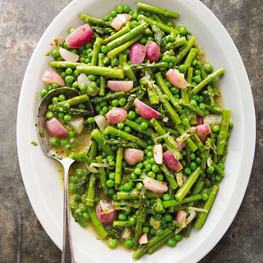 This undated photo provided by America's Test Kitchen in April 2019 shows Braised Spring Vegetables with Tarragon in Brookline, Mass. This recipe appears in the cookbook “How to Braise Everything.” (Joe Keller/America's Test Kitchen via AP)