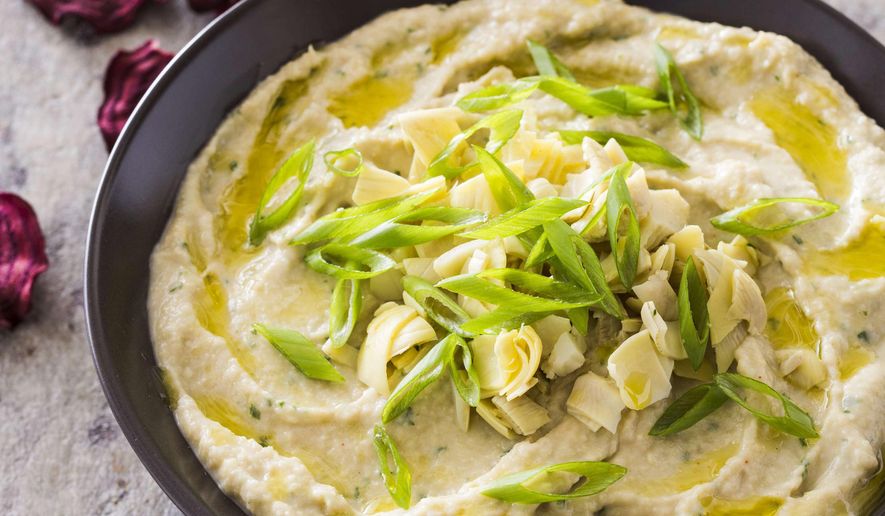 This undated photo provided by America's Test Kitchen in April 2019 shows Navy Bean and Artichoke Dip in Brookline, Mass. This recipe appears in the cookbook “Nutritious Delicious.” (Joe Keller/America's Test Kitchen via AP)