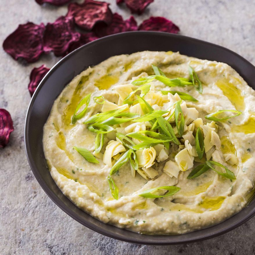 This undated photo provided by America's Test Kitchen in April 2019 shows Navy Bean and Artichoke Dip in Brookline, Mass. This recipe appears in the cookbook “Nutritious Delicious.” (Joe Keller/America's Test Kitchen via AP)