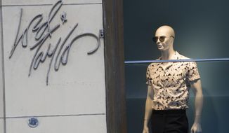 FILE - In this June 6, 2018, file photo the Lord &amp;amp; Taylor logo is seen next to a mannequin in a window display at their flagship store on Fifth Avenue in New York. Lord &amp;amp; Taylor, one of the country’s oldest department stores, may be sold as its owner considers its options. Hudson&#39;s Bay Co., which also owns Saks Fifth Avenue, says it hired a financial adviser to review Lord &amp;amp; Taylor’s business and that the process may lead to a sale or merger. (AP Photo/Mary Altaffer, File)