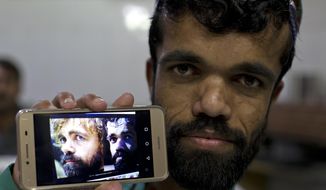 In this Friday, May 3, 2019 photo, Rozi Khan, a 26-year-old Pakistani shows his picture on his phone next to a picture of the U.S. actor Peter Dinklage who plays Tyrion Lannister on the TV series “Game of Thrones,” in Rawalpindi, Pakistan. Khan does not only have a similar look, haircut and beard as Dinklage, but the two share a genetic condition that results in small stature. (AP Photo/B.K. Bangash)