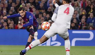 Barcelona&#39;s Philippe Coutinho, left, shoots on goal as Liverpool&#39;s Virgil Van Dijk tries to block the shot during the Champions League semifinal first leg soccer match between FC Barcelona and Liverpool at the Camp Nou stadium in Barcelona, Spain, Wednesday, May 1, 2019. (AP Photo/Manu Fernandez)