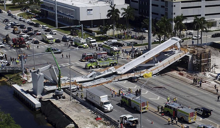 FILE - In this March 15, 2018, file photo, emergency personnel respond after a brand-new pedestrian bridge collapsed onto a highway at Florida International University in Miami. Just hours before the pedestrian bridge collapsed and killed six people at the Miami university, engineers confirmed that cracks in the concrete structure "increased in length daily." The Florida Department of Transportation released documents Monday, May 6, 2019, related to the March 2018 collapse of bridge at the university. (Pedro Portal/Miami Herald via AP, File)