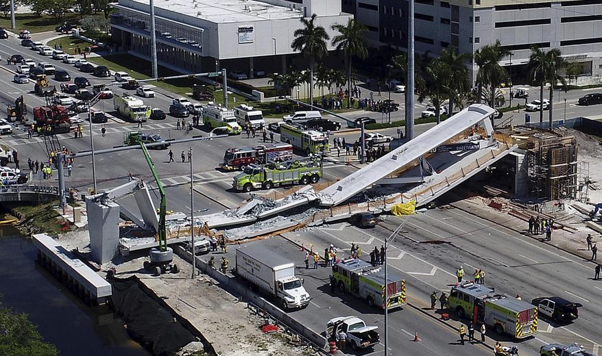 FILE - In this March 15, 2018, file photo, emergency personnel respond after a brand-new pedestrian bridge collapsed onto a highway at Florida International University in Miami. Just hours before the pedestrian bridge collapsed and killed six people at the Miami university, engineers confirmed that cracks in the concrete structure "increased in length daily." The Florida Department of Transportation released documents Monday, May 6, 2019, related to the March 2018 collapse of bridge at the university. (Pedro Portal/Miami Herald via AP, File)