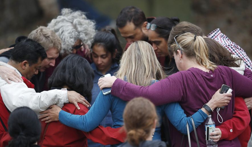 Parents gather in a circle to pray at a recreation center where students were reunited with their parents after a shooting at a suburban Denver middle school Tuesday, May 7, 2019, in Highlands Ranch, Colo. (AP Photo/David Zalubowski)