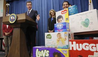 Gov. Gavin Newsom gestures towards boxes of tampons and diapers after proposing to eliminate from the state sales tax on such products in his upcoming state budget during a news conference, Tuesday, May 7, 2019, in Sacramento, Calif. The tax cuts are part of a &amp;quot;parents&#39; agenda&amp;quot; Newsom is pursuing, and he plans to unveil a revised state budget later this week. Newsom was, accompanied by his wife, first partner Jennifer Siebel Newsom, center, Southern California Democratic Assemblywoman Monique Limon, right, and others.(AP Photo/Rich Pedroncelli)