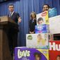 Gov. Gavin Newsom gestures towards boxes of tampons and diapers after proposing to eliminate from the state sales tax on such products in his upcoming state budget during a news conference, Tuesday, May 7, 2019, in Sacramento, Calif. The tax cuts are part of a &amp;quot;parents&#39; agenda&amp;quot; Newsom is pursuing, and he plans to unveil a revised state budget later this week. Newsom was, accompanied by his wife, first partner Jennifer Siebel Newsom, center, Southern California Democratic Assemblywoman Monique Limon, right, and others.(AP Photo/Rich Pedroncelli)