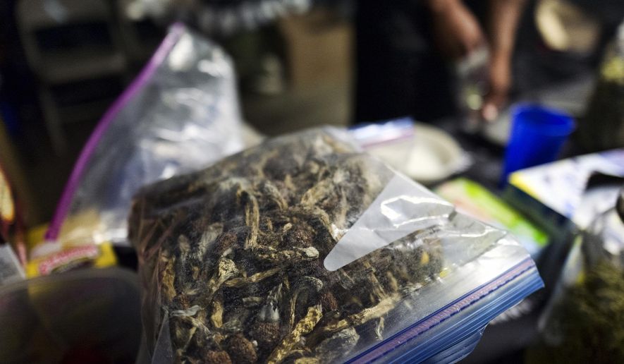 A vendor bags psilocybin mushrooms at a pop-up cannabis market in Los Angeles on Monday, May 6, 2019. Voters decide this week whether Denver will become the first U.S. city to decriminalize the use of psilocybin, the psychedelic substance in &amp;quot;magic mushrooms.&amp;quot; (AP Photo/Richard Vogel)