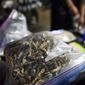 A vendor bags psilocybin mushrooms at a pop-up cannabis market in Los Angeles on Monday, May 6, 2019. Voters decide this week whether Denver will become the first U.S. city to decriminalize the use of psilocybin, the psychedelic substance in &amp;quot;magic mushrooms.&amp;quot; (AP Photo/Richard Vogel)