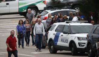 Parents head into a recreation center for students to get reunited with their parents after a shooting Tuesday, May 7, 2019, in Highlands Ranch, Colo. (AP Photo/David Zalubowski)