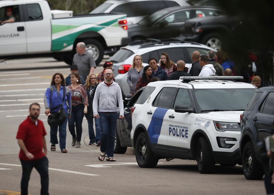 Parents head into a recreation center for students to get reunited with their parents after a shooting Tuesday, May 7, 2019, in Highlands Ranch, Colo. (AP Photo/David Zalubowski)