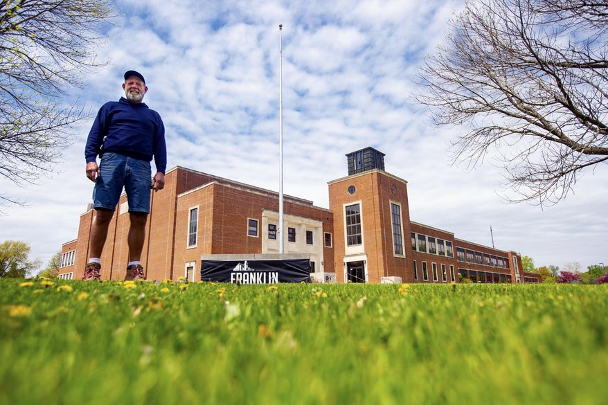 Jeff Young, owner of the Franklin Jr. High building in Des Moines stands for a photo in front of the building Monday, May 6, 2019. Young needs just one more city council vote before he can implement proposed plans to transform the former Des Moines junior high school into an eclectic space featuring meeting rooms, restaurants, a bar and boutique hotel. (Zach Boyden-Holmes/The Des Moines Register via AP)