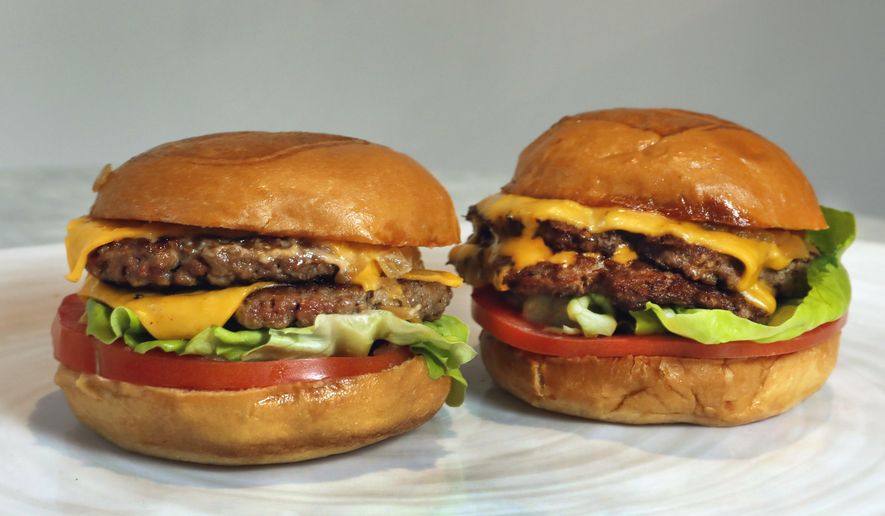 An Original Impossible Burger, left, and a Cali Burger, from Umami Burger, are shown in this photo in New York, Friday, May 3, 2019. A recent study published in the American Journal of Clinical Nutrition suggests that opting for vegan meat products, such as faux sausages and burgers, does not provide a clear advantage for heart health and may even be associated with higher blood pressure in some cases. (AP Photo/Richard Drew)