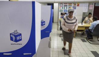 An electoral worker walks past polling booths readied ahead of Wednesday&#39;s election, at a polling station in downtown Johannesburg, South Africa Tuesday, May 7, 2019. The upcoming elections will take place 25 years after the end of apartheid and are the country&#39;s sixth all-race polls. (AP Photo/Ben Curtis)