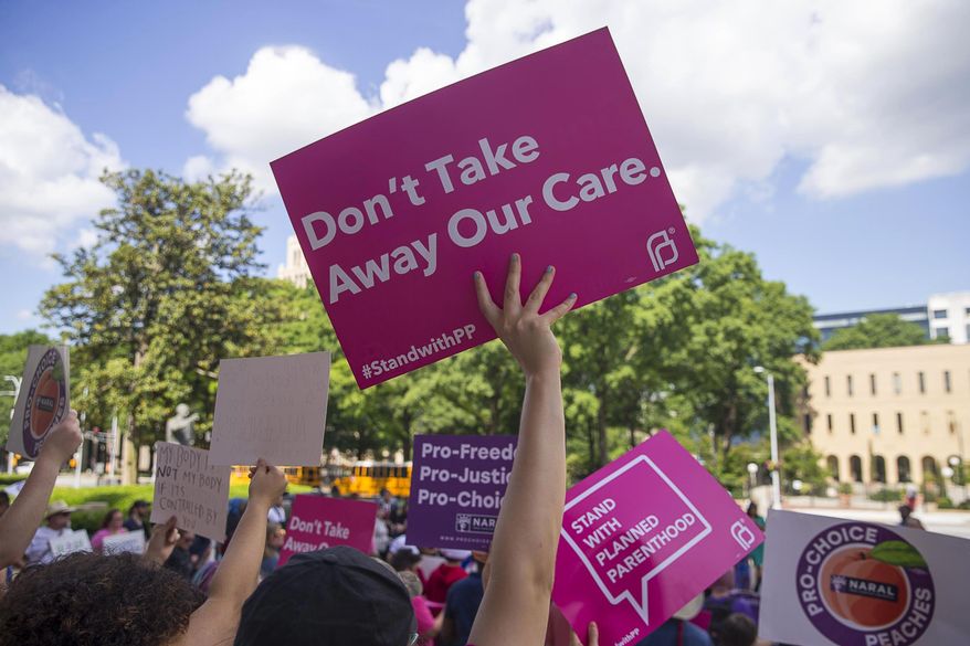 FILE - In this Tuesday, May 7, 2019, file photo, protesters rally outside of the Georgia State Capitol following the signing of HB 481, in Atlanta. Georgia Governor Brian Kemp signed legislation on Tuesday banning abortions once a fetal heartbeat can be detected. (Alyssa Pointer/Atlanta Journal-Constitution via AP, File)