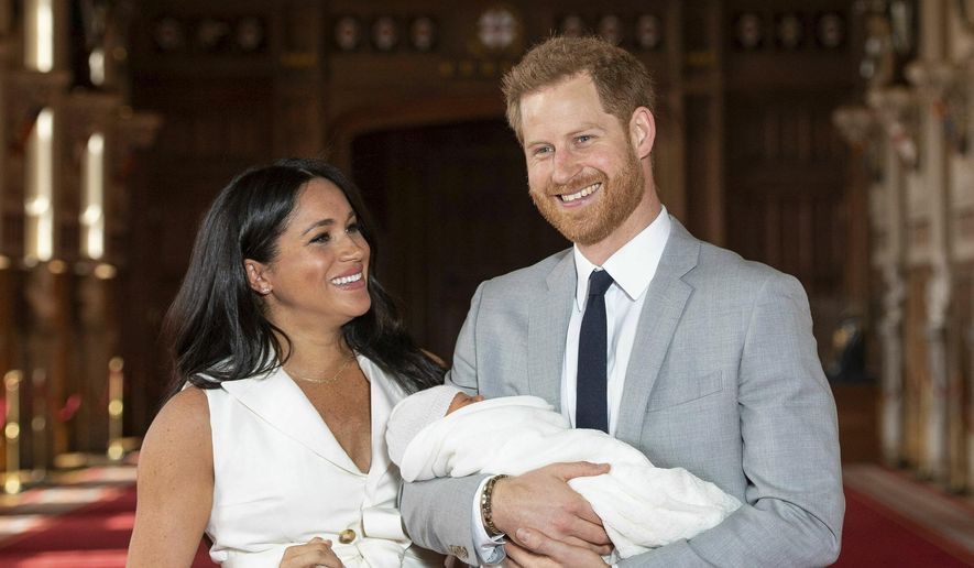 Britain's Prince Harry and Meghan, Duchess of Sussex, during a photocall with their newborn son, in St George's Hall at Windsor Castle, Windsor, south England, Wednesday May 8, 2019. Baby Sussex was born Monday at 5:26 a.m. (0426 GMT; 12:26 a.m. EDT) at an as-yet-undisclosed location. An overjoyed Harry said he and Meghan are "thinking" about names. (Dominic Lipinski/Pool via AP)