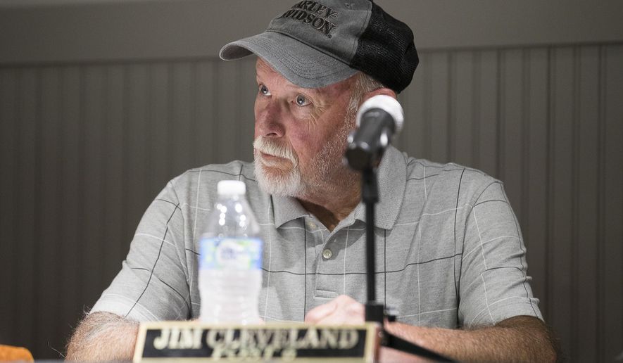 Hoschton City Councilman Jim Cleveland listens during a city council meeting at the Hoschton Historic Train Depot in Hoschton, Ga., Monday, May 6, 2019. The mayor of the mostly white north Georgia city, Theresa Kenerly, is being criticized for comments attributed to her that the community isn&#39;t ready to have an African American city administrator. Cleveland is supporting Kenerly. (Alyssa Pointer/Atlanta Journal-Constitution via AP)