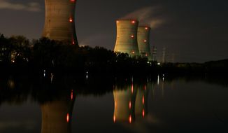 FILE - In this Nov. 2, 2006, file photo, cooling towers of the Three Mile Island nuclear power plant are reflected in the Susquehanna River in this image taken with a slow shutter speed in Middletown, Pa. The owner of Three Mile Island, site of the United States&#39; worst commercial nuclear power accident, is acknowledging in a Wednesday, May 8, 2019 statement that it is unlikely to get a financial rescue from Pennsylvania and says it plans to go through with a shutdown starting June 1. (AP Photo/Carolyn Kaster, File)