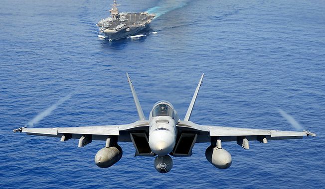 An F/A-18E Super Hornet from the Tophatters of Strike Fighter Squadron (VFA) 14 participates in an air power demonstration over the aircraft carrier USS John C. Stennis (CVN 74). The John C. Stennis Carrier Strike Group is returning from an eight-month deployment to the U.S. 5th and 7th Fleet areas of responsibility. (U.S. Navy Photo by Mass Communication Specialist Seaman Apprentice Ignacio D. Perez/Released) 