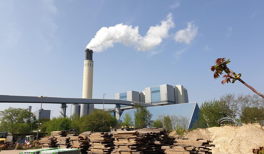 A chimney billows out steam at Berlin's Reuter West thermal power station on Wednesday, April 24, 2019. The energy company, together with a Swedish start-up, is testing the use of salt to store heat, which accounts for more than half the power consumed in Germany. (AP Photos/Frank Jordans)