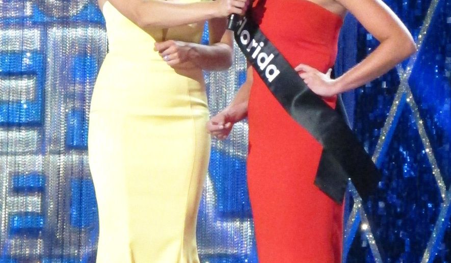 Miss America 2015 Kira Kazantsev, left, conducts an onstage interview with Miss Florida Taylor Tyson during the second night of preliminary competition in the Miss America competition in Atlantic City N.J. on Thursday Sept. 6, 2018. Tourism generated $44.7 billion in spending in New Jersey in 2018, Gov. Phil Murphy announced on May 9, 2019. (AP Photo/Wayne Parry)