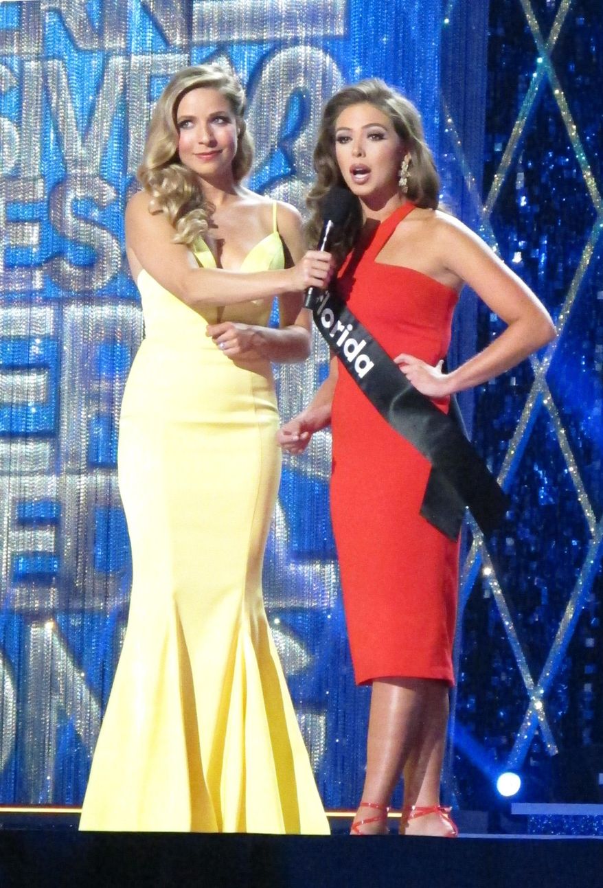 Miss America 2015 Kira Kazantsev, left, conducts an onstage interview with Miss Florida Taylor Tyson during the second night of preliminary competition in the Miss America competition in Atlantic City N.J. on Thursday Sept. 6, 2018. Tourism generated $44.7 billion in spending in New Jersey in 2018, Gov. Phil Murphy announced on May 9, 2019. (AP Photo/Wayne Parry)