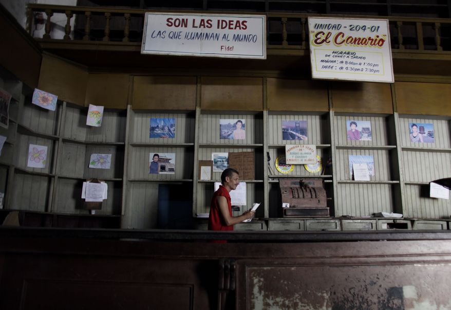 In this Oct. 9, 2009, file photo, an employee works in a government food store with empty shelves in Havana, Cuba. The Cuban government said, Friday, May 10, 2019, that it will begin rationing chicken, eggs, rice, beans, soap and other basic products in the face of a grave economic crisis. (AP Photo/Javier Galeano, File)