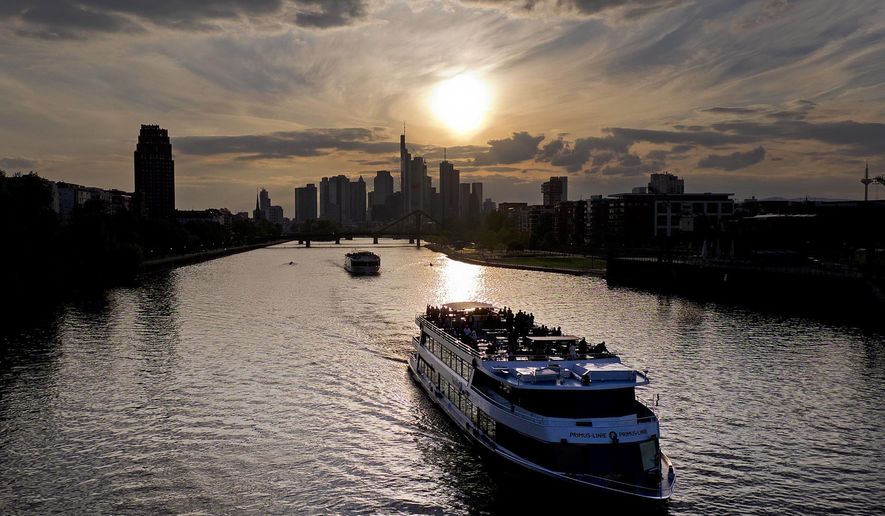 Cruise ships are seen on the river Main during sun set in Frankfurt, Germany, Tuesday, May 7, 2019. (AP Photo/Michael Probst)