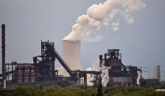 A power plant steams behind steel works of German steelmaker Thyssenkrupp in Duisburg, Germany, Thursday, May 9, 2019. Steelmaking giant Thyssenkrupp of Germany says it expects European antitrust regulators to block its plan to combine its European operations with India&#x27;s Tata Steel. (AP Photo/Martin Meissner)
