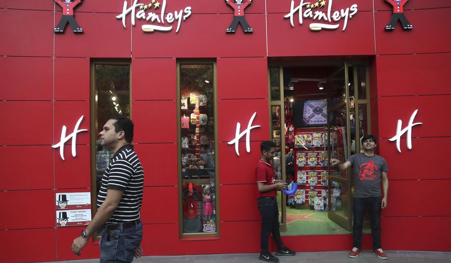 A shopper walks past a Hamleys store in New Delhi, India, Friday, May 10, 2019. India's Reliance Retail, a subsidiary of Reliance Industries Limited, announced Thursday that it has signed agreements to acquire the 259-year-old British toy store chain Hamleys. (AP Photo/Manish Swarup)