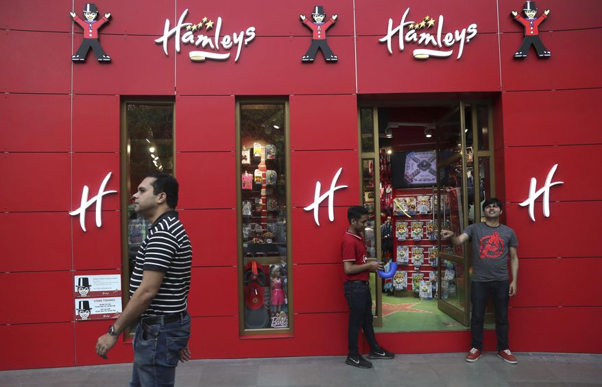 A shopper walks past a Hamleys store in New Delhi, India, Friday, May 10, 2019. India's Reliance Retail, a subsidiary of Reliance Industries Limited, announced Thursday that it has signed agreements to acquire the 259-year-old British toy store chain Hamleys. (AP Photo/Manish Swarup)