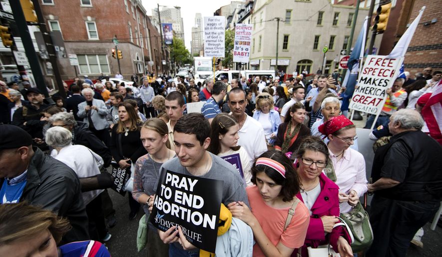 Anti-abortion protesters rally near a Planned Parenthood clinic in Philadelphia, Friday, May 10, 2019. The demonstration was spurred by the actions of a Democratic state lawmaker who recorded himself berating an anti-abortion demonstrator at length outside the clinic. (AP Photo/Matt Rourke)