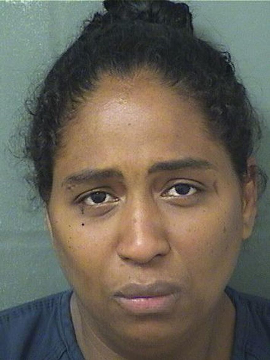 This May 9, 2019 photo made available by the Palm Beach County Sherif's Office shows Rafaelle Sousa under arrest. Sousa is charged with attempted murder and child abuse after she delivered a baby girl, put her in a plastic bag and tossed her into a dumpster. The baby was found alive. (Palm Beach County Sheriff's Office via AP)