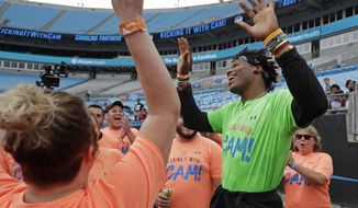 Carolina Panthers Cam Newton, right, celebrates as participants sing &amp;quot;Happy Birthday&amp;quot; during his charity kickball tournament in Charlotte, N.C., Friday, May 10, 2019. Both Panthers QBs will be action Friday. Cam Newton will be on the field at Bank of America Stadium throwing balls _ kickballs, that is _ as part of his annual Kicking it with Cam Kickball Tournament. Meanwhile rookie draft pick QB Will Grier will throwing footballs for the first time as Carolina opens rookie minicamp on the team&#39;s practice fields outside the stadium. (AP Photo/Chuck Burton)