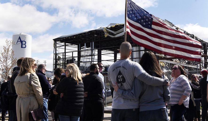 Attendees listen during a memorial, Friday morning, May 10, 2019, in Waukegan, Ill. , for the victims of a recent explosion at the AB Specialty Silicones plant. (Joe Lewnard/Daily Herald via AP)