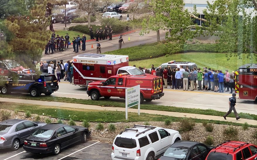 FILE - In this Tuesday, May 7, 2019 file photo, police officers and students are seen outside STEM School Highlands Ranch, a charter middle school in the Denver suburb of Highlands Ranch, Colo., after a shooting. Both suspects in the suburban Denver school shooting are due back in court Friday, May 10, as prosecutors file charges in the violent attack that killed a student and wounded multiple others. Authorities have identified the suspects as 18-year-old Devon Erickson and 16-year-old Maya McKinney, whose attorney said uses male pronouns and the name Alec. (Courtney Harper via AP, File)
