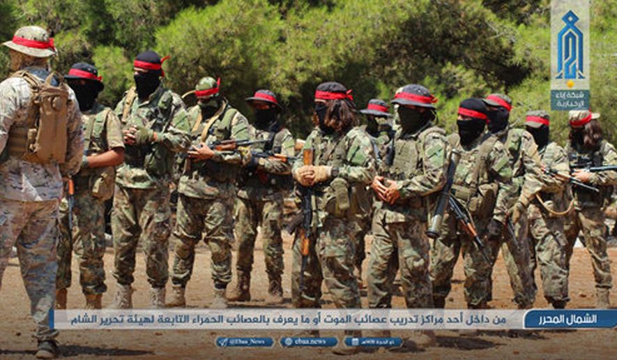 FILE - This Aug 20, 2018 photo, provided by the al-Qaida-affiliated Ibaa News Network, shows fighters of the al-Qaida-linked coalition known as Hay'at Tahrir al-Sham, training in Idlib province, Syria. After eight months of relative calm, Idlib is once again a theater for bloody military operations as Syrian government troops, backed by Russia, push their way into the rebel-held enclave in a widening offensive. The violence in May 2019 threatens to completely unravel a crumbling cease-fire agreement reached between Turkey and Russia last September. (Ibaa News Network, via AP, File)