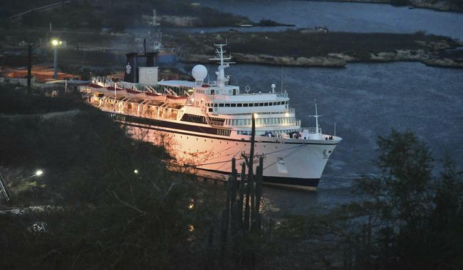 The Freewinds cruise ship is docked in the port of Willemstad, Curacao Saturday, May 4, 2019. Authorities in Curacao on Saturday boarded the ship that arrived in the Dutch Caribbean island under quarantine, to start vaccinating people to prevent a measles outbreak. Health officials said only those who already have been vaccinated or have previously had measles will be free to leave the 440-foot (134-meter) ship Freewinds.  (AP Photo/Dick Drayer)