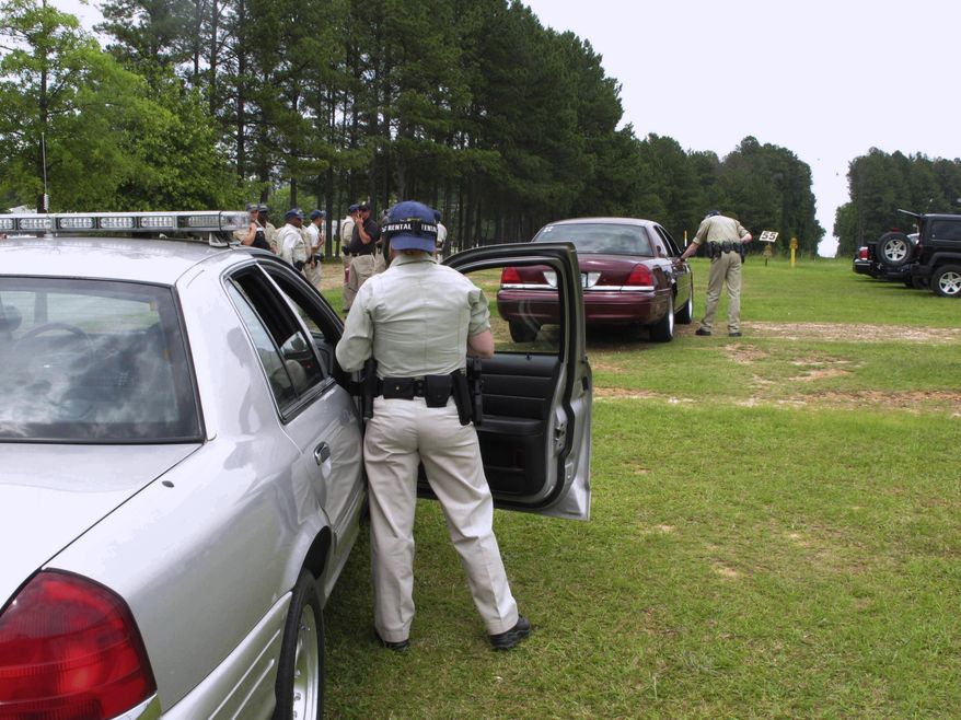 FILE - In this May 11, 2017 file photo trainees practice pulling over a car in an exercise at the South Carolina Criminal Justice Academy in Columbia, S.C. The South Carolina Criminal Justice Academy will be changing how it operates its 12-week basic training program to get new officers into squad cars and int the community faster. Trainees will be taking a 4-week “at home” video training course before arriving on campus for the remaining 8-weeks of training. (AP Photo/Jeffrey Collins, file)