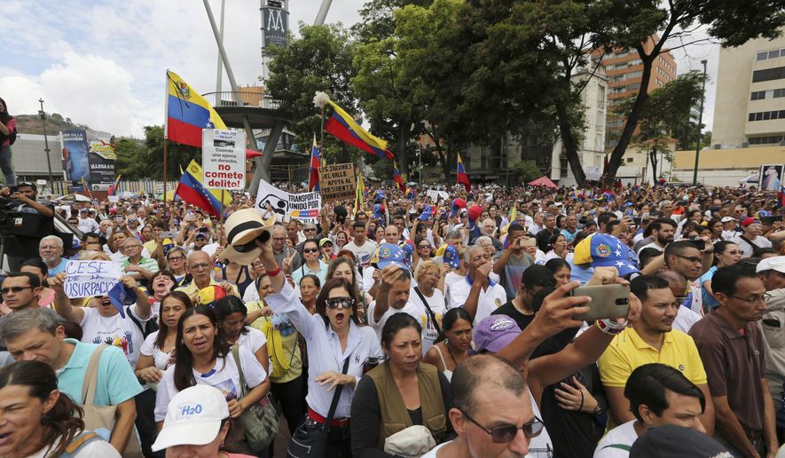 Opponents of Nicolas Maduro's government attend a rally led by opposition leader Juan Guaidó, in Caracas, Venezuela, Saturday, May 11, 2019. Guaidó has called for nationwide marches protesting the Maduro government, demanding new elections and the release of jailed opposition lawmakers. (AP Photo/Fernando Llano)