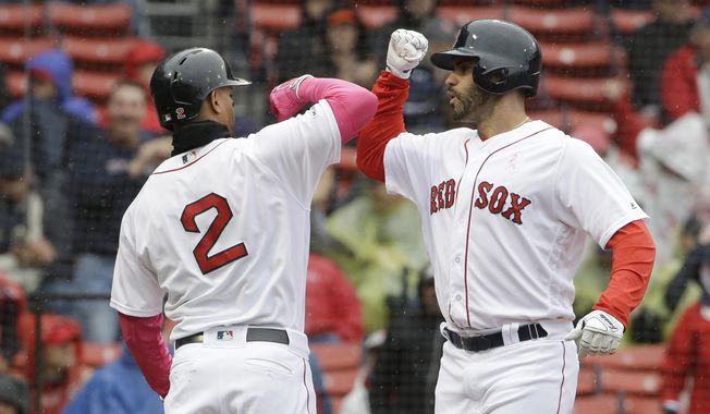 Boston Red Sox&#x27;s Xander Bogaerts, left, welcomes home J.D. Martinez, right, after Martinez hit a homerun off a pitch by Seattle Mariners&#x27; Marco Gonzales during the first inning of a baseball game at Fenway Park, Sunday, May 12, 2019, in Boston. (AP Photo/Steven Senne)