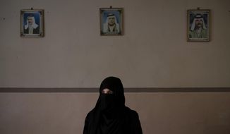 In this April 14, 2019 photo, Khadija Abd poses for a portrait in her family&#39;s house in Mosul, Iraq. On a chilly January evening, the Abd family had just finished supper at their farm when the two men with guns burst into the room. They said they were from the Iraqi army. In fact, they were Islamic State group militants who had come down from the surrounding mountains into Badoush with one thing on their mind: Revenge. (AP Photo/Felipe Dana)