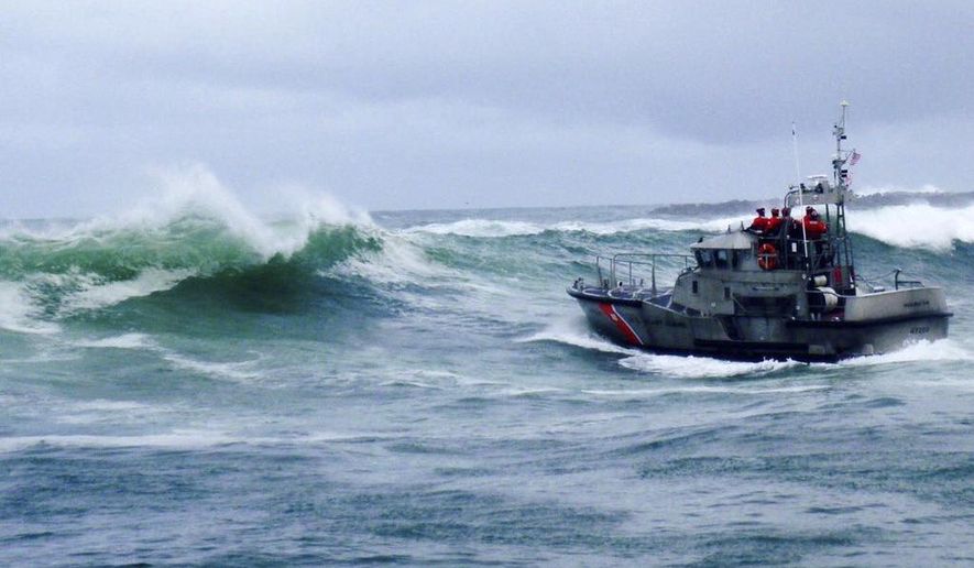 FILE - In this Tuesday, Jan. 8, 2019 file photo, provided by the U.S. Coast Guard, a U.S. Coast Guard boat crew responds to three fishermen in the water after the commercial fishing vessel Mary B II capsized while crossing Yaquina Bay Bar off the coast of Newport, Ore. The U.S. Coast Guard is holding a public hearing Monday, May 13, 2019, n Newport, Oregon to review its handling of a crab boast sinking that killed 3 crabbers off the Oregon coast earlier this year. (U.S. Coast Guard via AP, File)
