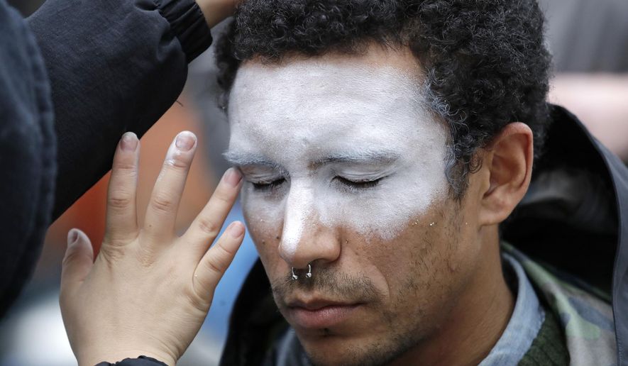  In this Oct. 31, 2018, file photo, a man, who declined to be identified, has his face painted to represent efforts to defeat facial recognition during a protest at Amazon headquarters over the company&#39;s facial recognition system, &amp;quot;Rekognition,&amp;quot; in Seattle.  (AP Photo/Elaine Thompson, File)  **FILE**